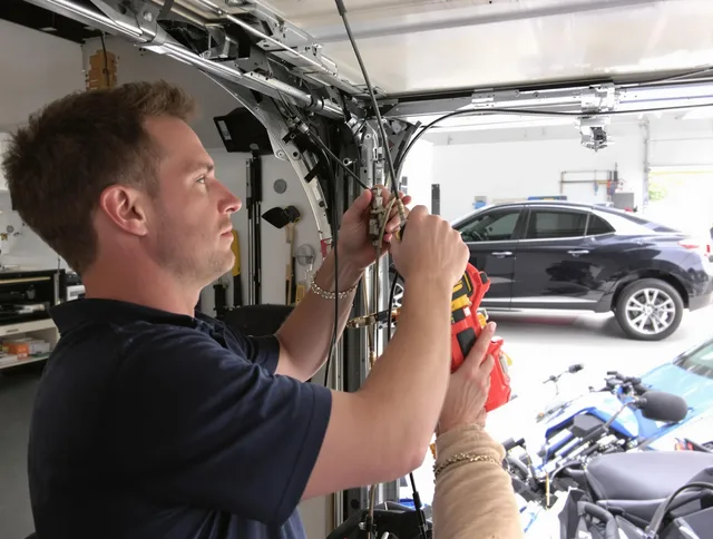 Port St. Lucie Garage Door Repair safety certified technician performing cable replacement in Port St. Lucie