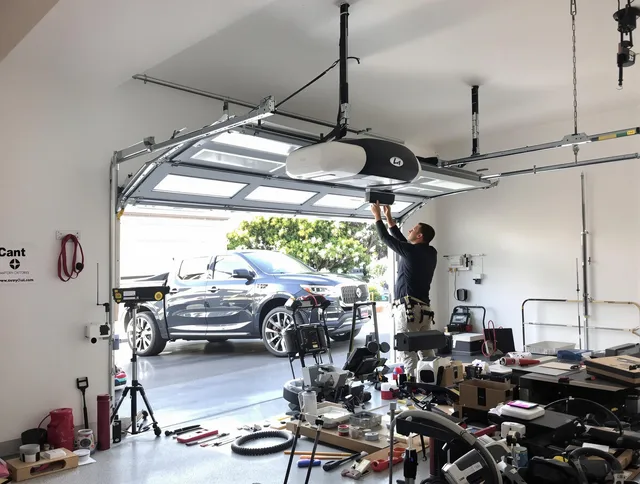 Port St. Lucie Garage Door Repair specialist installing smart garage door opener system in Port St. Lucie home